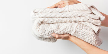 Two,White,Knitted,Woolen,Sweaters,Pullover,In,A,Stack,In